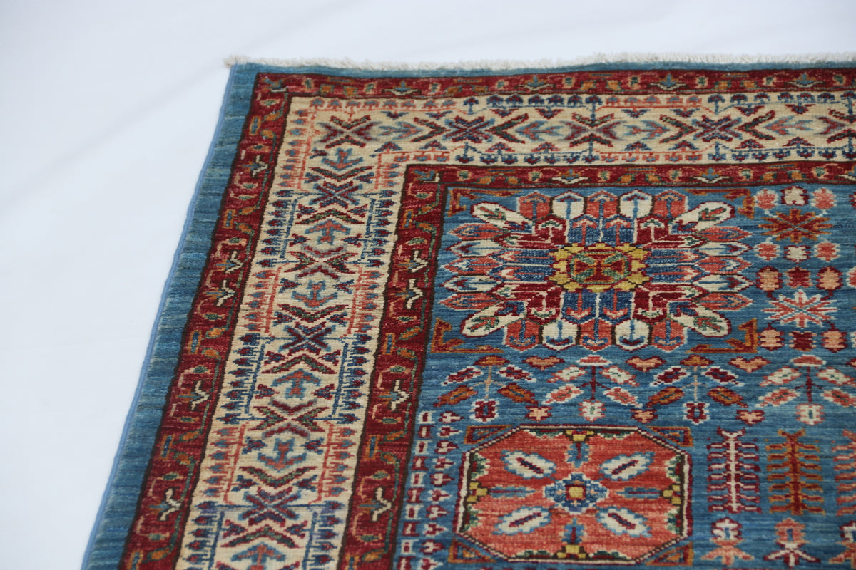 Detail 4 of blue floral Super Kazak cotton-and-wool rug, 5 x 7 ft
