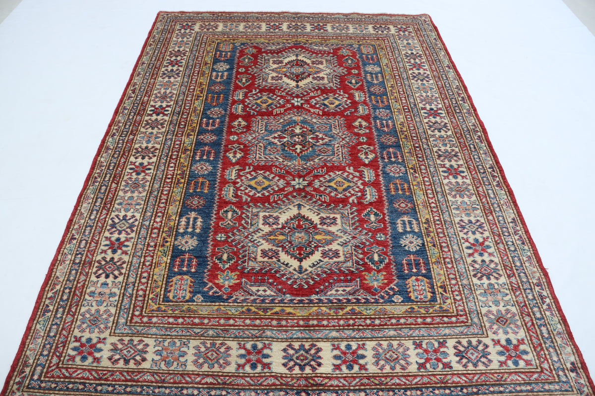Detail 2 of red floral Super Kazak cotton-and-wool rug, 5 x 7 ft