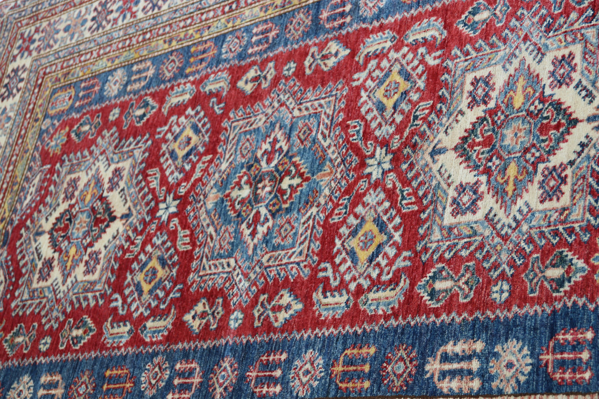 Detail 5 of red floral Super Kazak cotton-and-wool rug, 5 x 7 ft