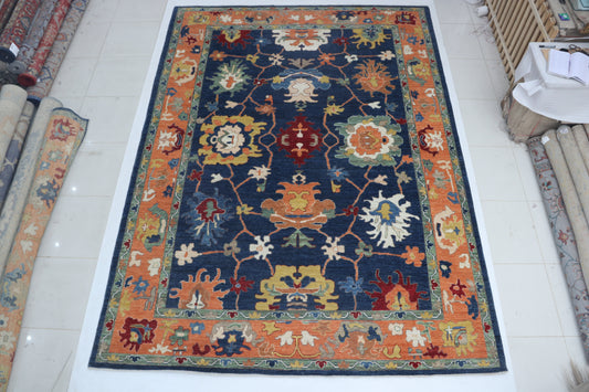 Full view of blue Oushak handwoven wool rug, 10 x 14 ft