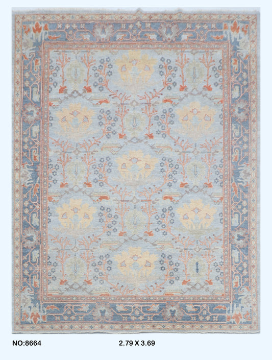 Full view of blue Oushak handwoven wool rug, 9 x 12 ft