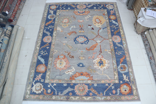 Full view of blue Oushak handwoven wool rug, 10 x 14 ft